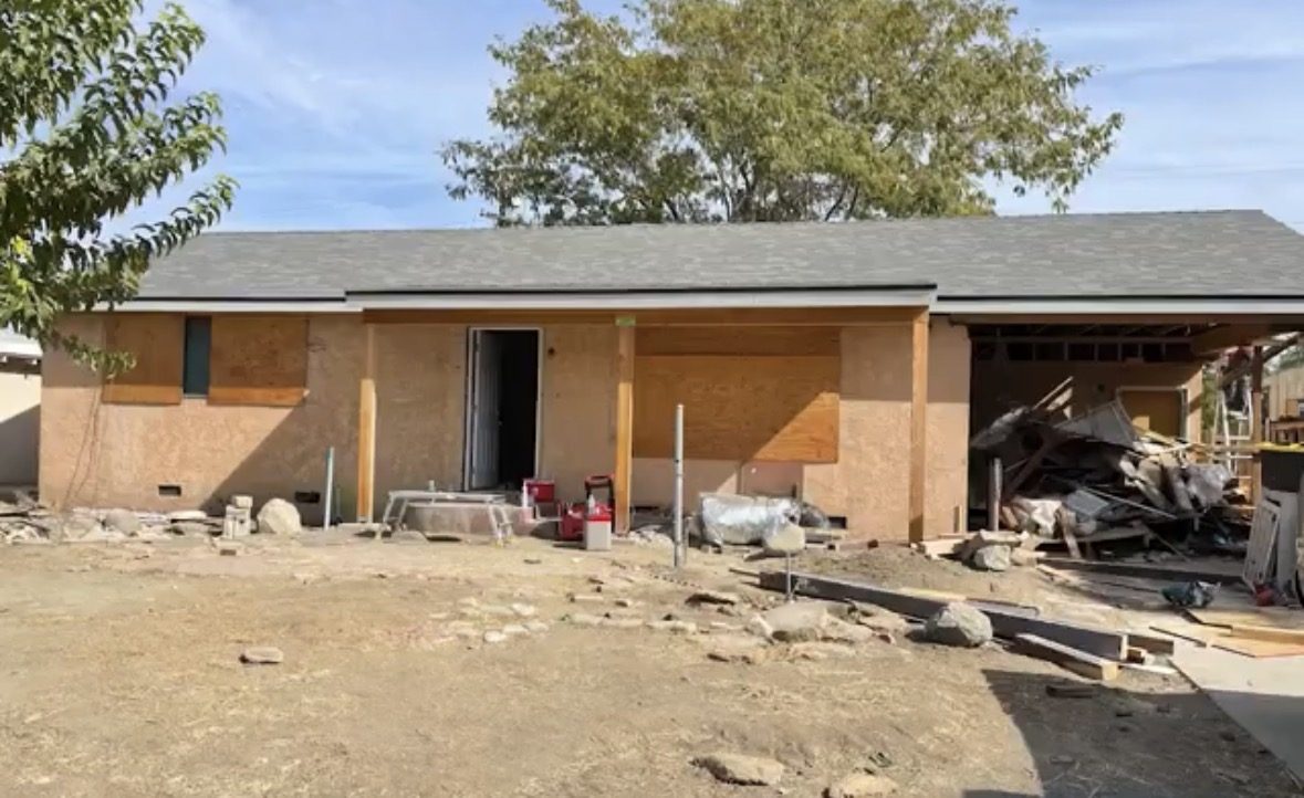 Visalia house before renovation, exterior stripped to framing